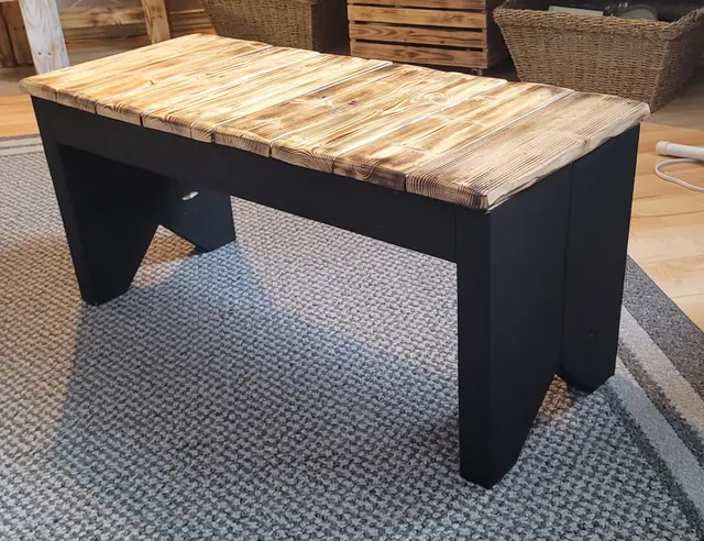 Rustic bench with black base and torched wood top