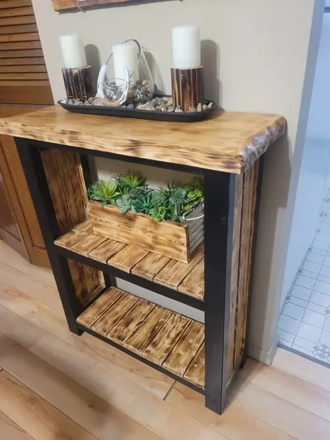 Black-framed rustic shelf with torched slats and a planter