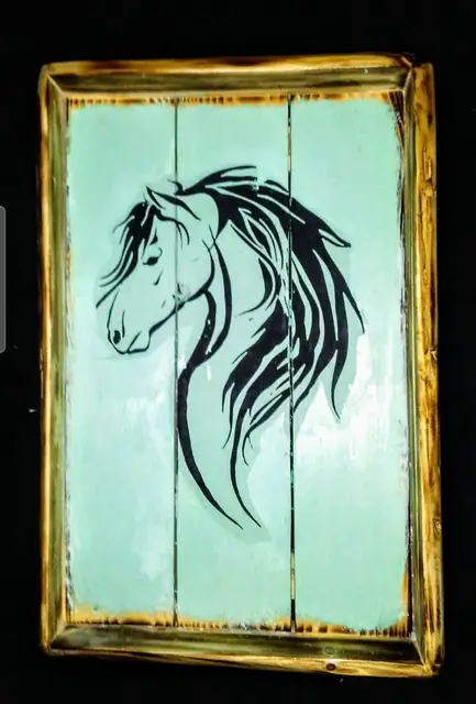 Black horse head decoupage on mint-painted plank sign with torched edges