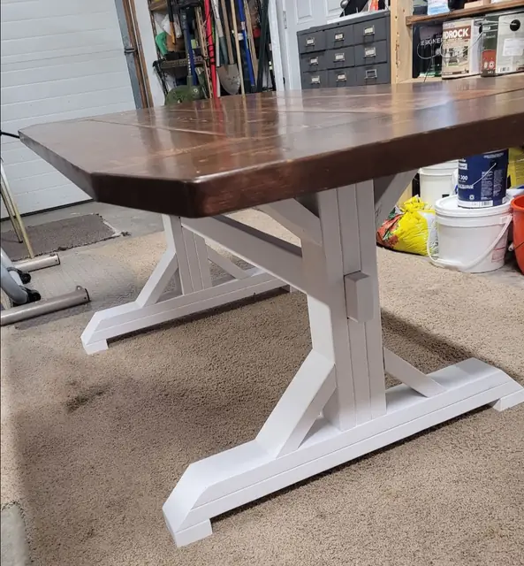 Close-up of a white trestle base on a handmade farmhouse dining table