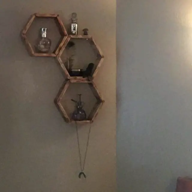 Three hexagon wall shelves in torched wood