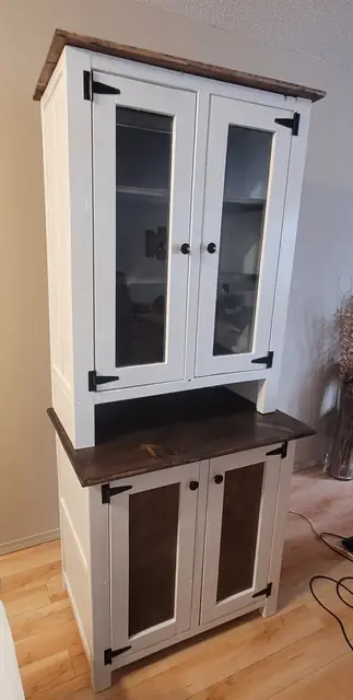 Tall custom hutch with white frame, glass doors and stained cabinet panels