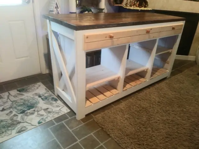 Custom kitchen island with white X-brace base, drawers and dark butcher top