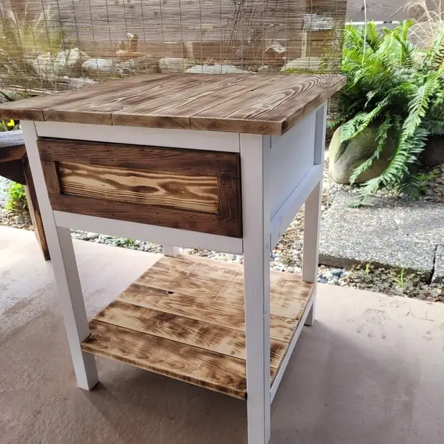 Rustic side table with stained drawer front, white legs and torched lower shelf