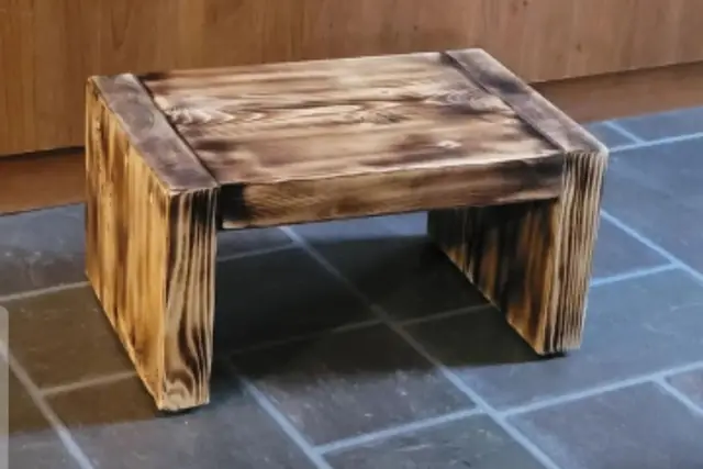 Small hand-torched wood bench