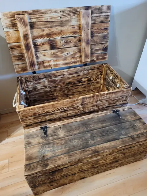 Hand-torched wood storage trunk with lid open
