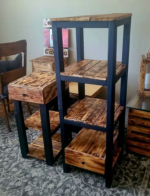 Tall black-framed shelf with torched slats beside matching drawer side tables