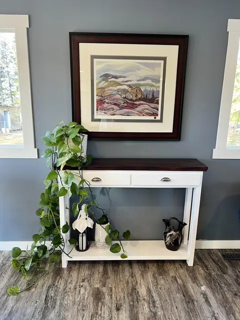 White console table with two drawers and dark stained top