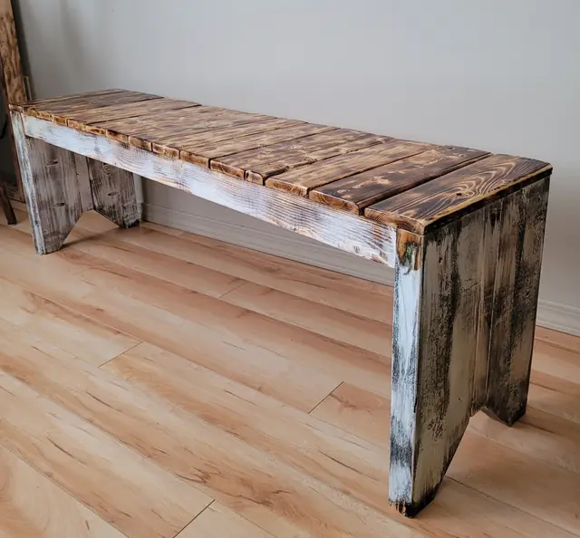 Rustic bench with white-washed legs and torched plank seat