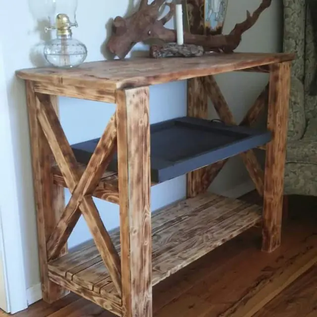 Rustic X-brace console table with torched finish and lower shelf